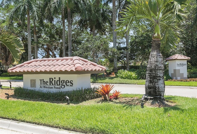 community / neighborhood sign with a yard