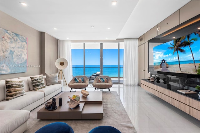 tiled living room with a water view and a wall of windows