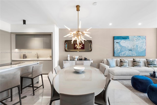 tiled dining room with a notable chandelier and sink