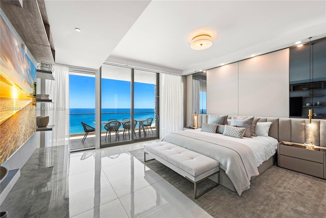 tiled bedroom featuring access to outside, a wall of windows, and a water view