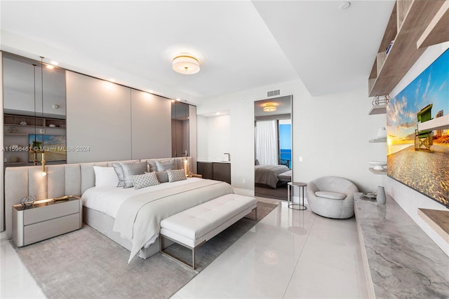 bedroom featuring light tile floors