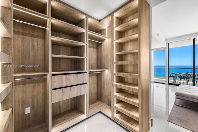 spacious closet with light tile flooring