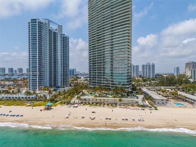 birds eye view of property with a view of the beach and a water view