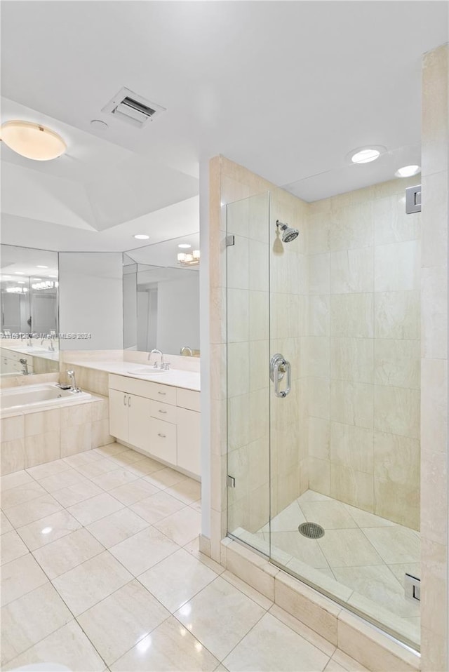 bathroom with vanity, tile patterned flooring, and plus walk in shower