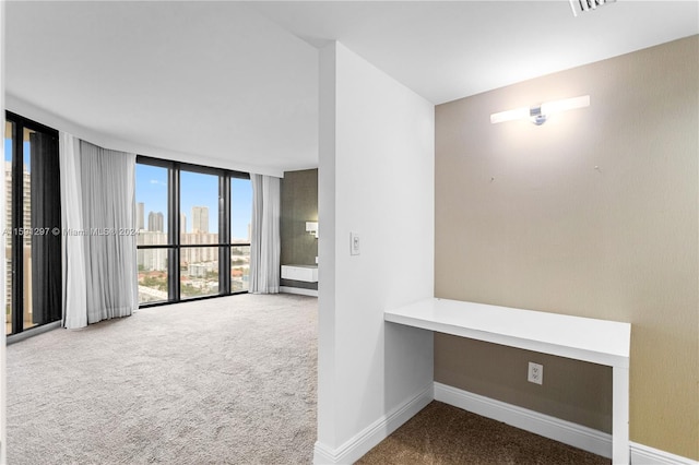 interior space featuring floor to ceiling windows and carpet floors