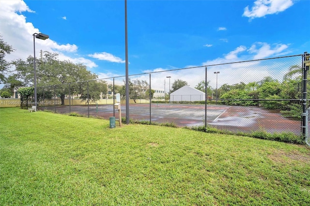 view of sport court featuring a yard