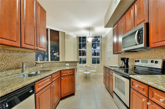 kitchen with light stone countertops, appliances with stainless steel finishes, backsplash, light tile flooring, and ceiling fan