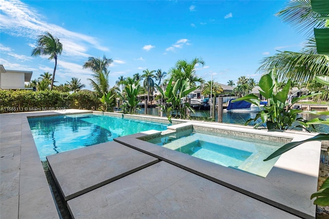 view of pool with a water view, a patio area, and a pool with connected hot tub