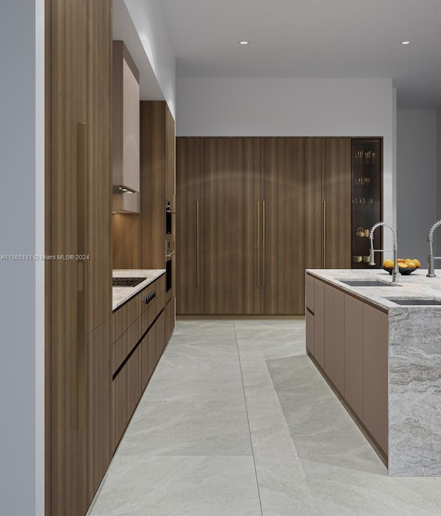 kitchen featuring light tile patterned floors, sink, and black gas cooktop