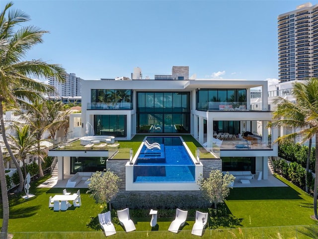 exterior space featuring a patio, a lawn, and a balcony