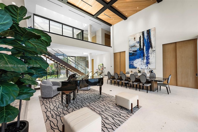 living room with a high ceiling and wood ceiling