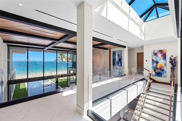 interior space with a skylight and a water view