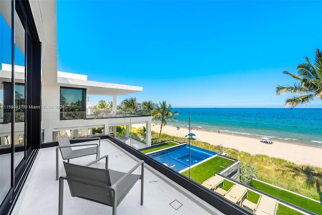 balcony featuring a water view and a view of the beach