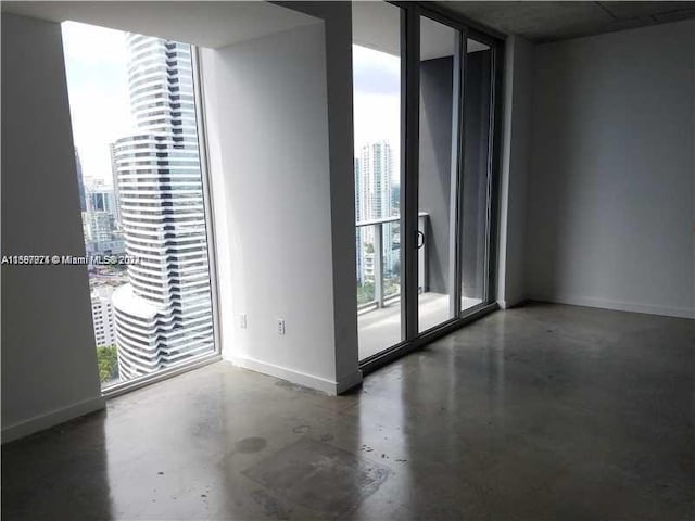 unfurnished room with floor to ceiling windows