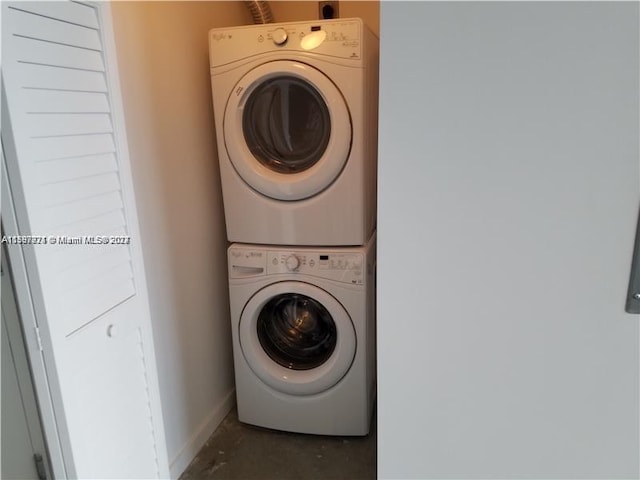 washroom featuring stacked washer / drying machine