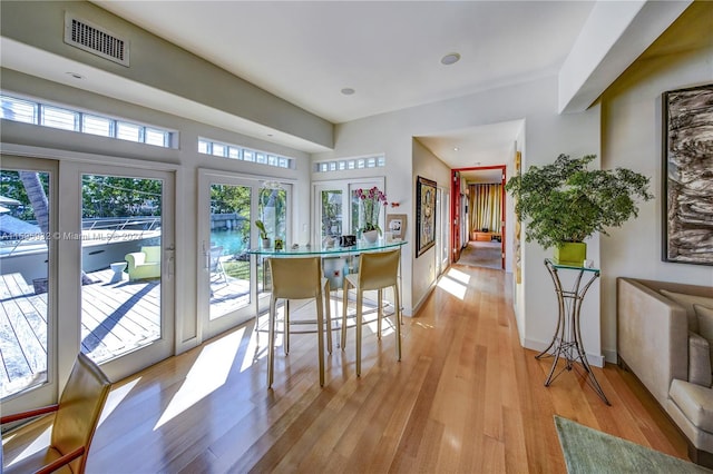 dining space featuring light hardwood / wood-style flooring and french doors