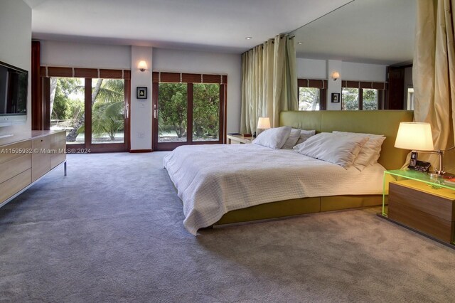 bedroom with access to outside and carpet floors