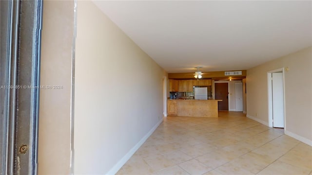 unfurnished living room featuring ceiling fan and light tile patterned flooring