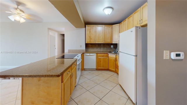 kitchen featuring white appliances, ceiling fan, light tile patterned floors, light brown cabinetry, and a kitchen bar