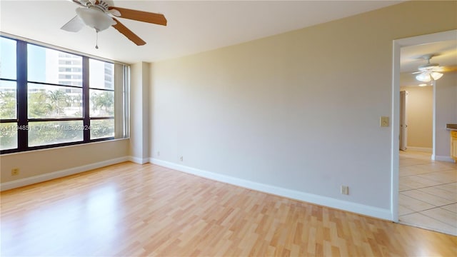 spare room with ceiling fan and light hardwood / wood-style flooring