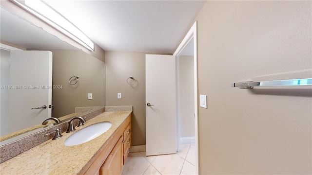 bathroom with tile patterned floors and vanity