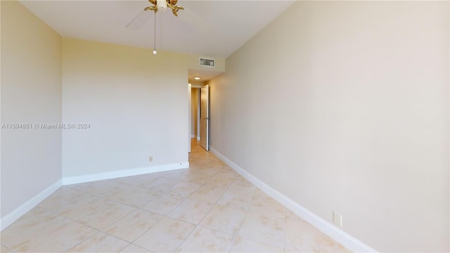 tiled empty room with ceiling fan