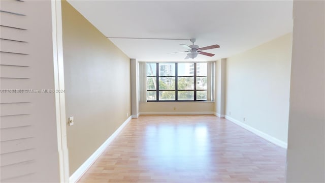 empty room with light hardwood / wood-style flooring and ceiling fan