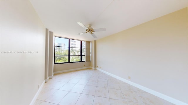 unfurnished room featuring ceiling fan and light tile patterned floors