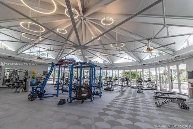 gym featuring ceiling fan and high vaulted ceiling