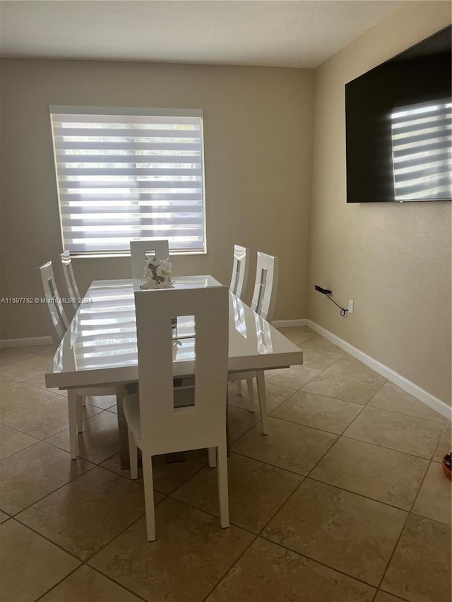 unfurnished dining area with light tile patterned floors