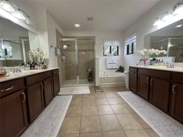 bathroom with shower with separate bathtub, vanity, and tile patterned floors