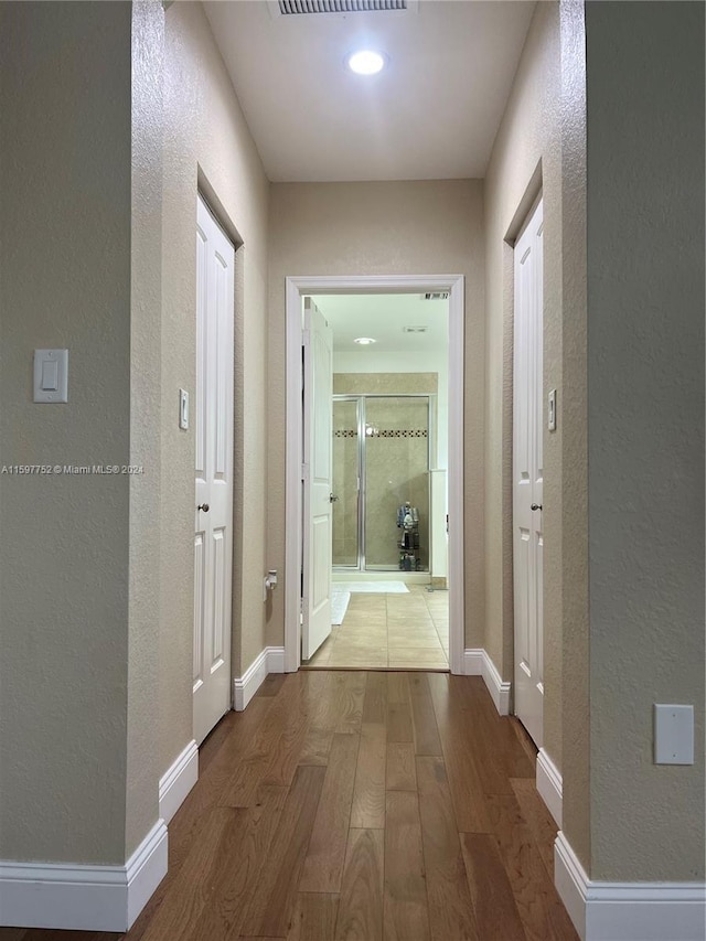 hall with hardwood / wood-style floors