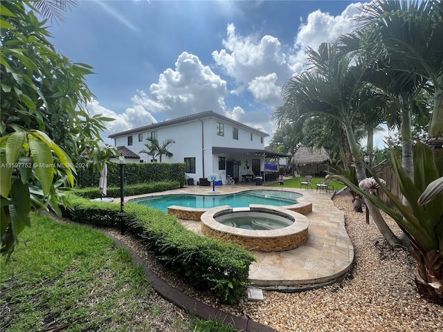 view of pool with an in ground hot tub and a patio