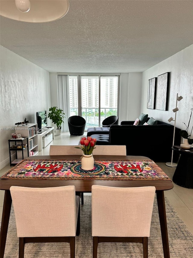 tiled dining area featuring a textured ceiling