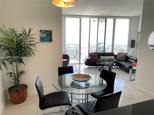 tiled dining area featuring a healthy amount of sunlight and floor to ceiling windows