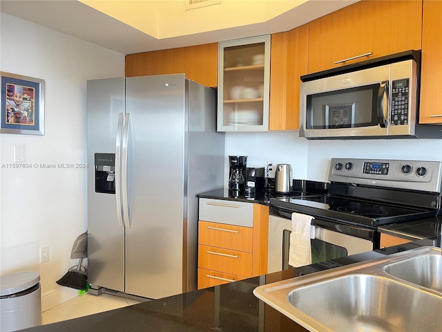 kitchen featuring appliances with stainless steel finishes and tile floors