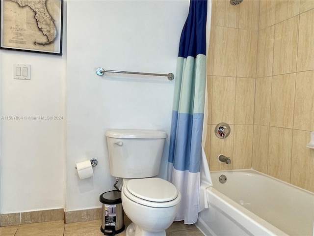 bathroom with tile flooring, toilet, and shower / tub combo with curtain