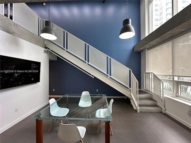 interior space featuring tile patterned flooring, plenty of natural light, and a high ceiling