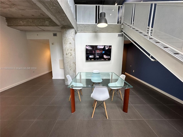 dining area with dark tile patterned floors