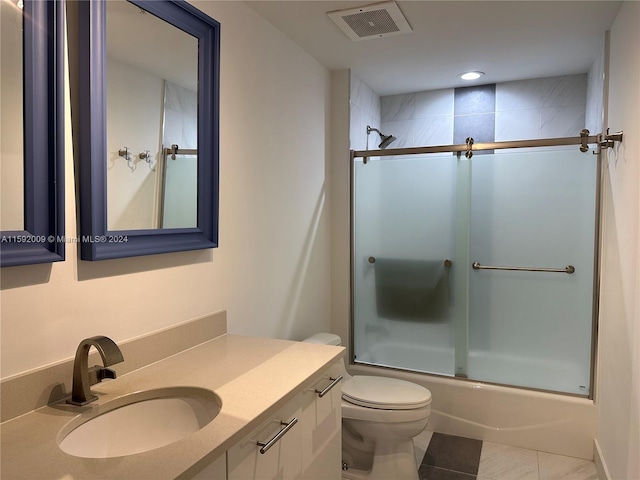 full bathroom with tile patterned flooring, vanity, toilet, and enclosed tub / shower combo