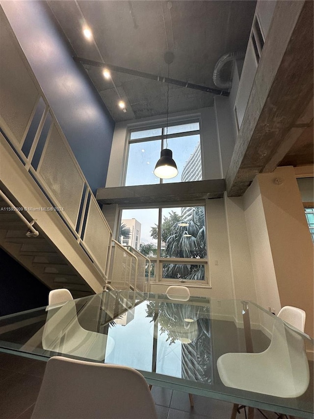 interior space featuring tile patterned floors and a towering ceiling