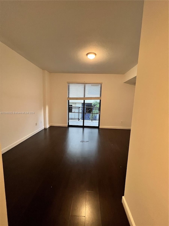 empty room featuring dark hardwood / wood-style floors