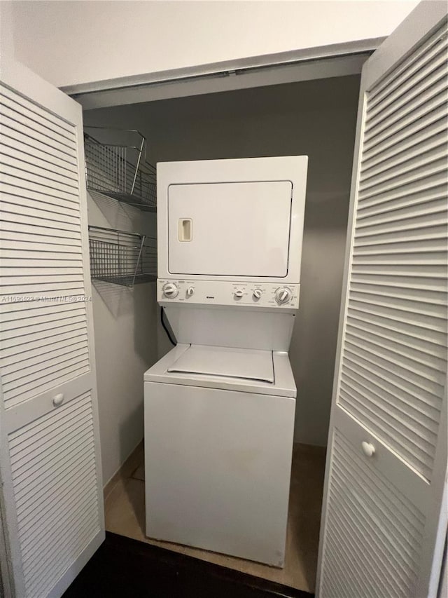 clothes washing area featuring stacked washing maching and dryer