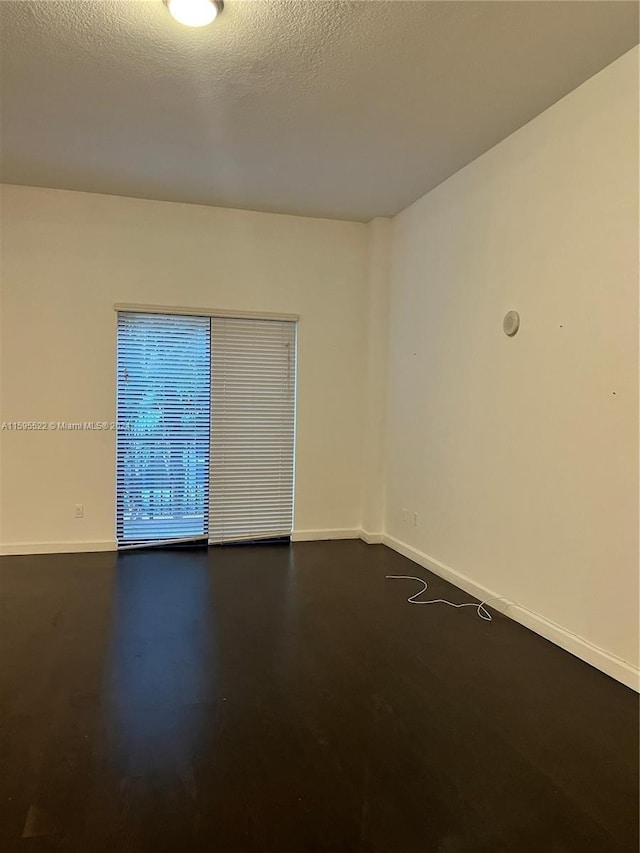 empty room with a textured ceiling