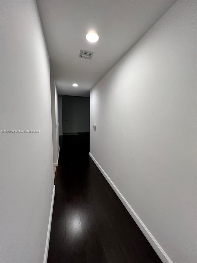 hallway with dark hardwood / wood-style floors