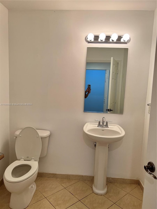 bathroom with tile patterned flooring and toilet