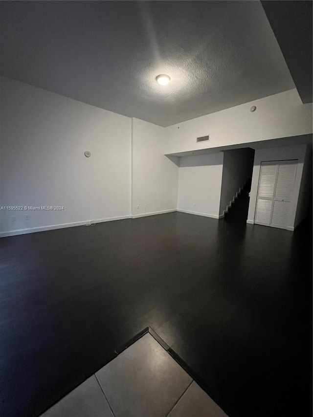 unfurnished room featuring a textured ceiling