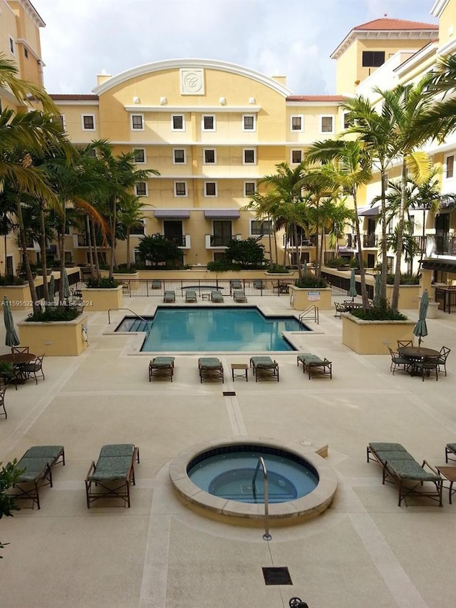 view of pool with a hot tub