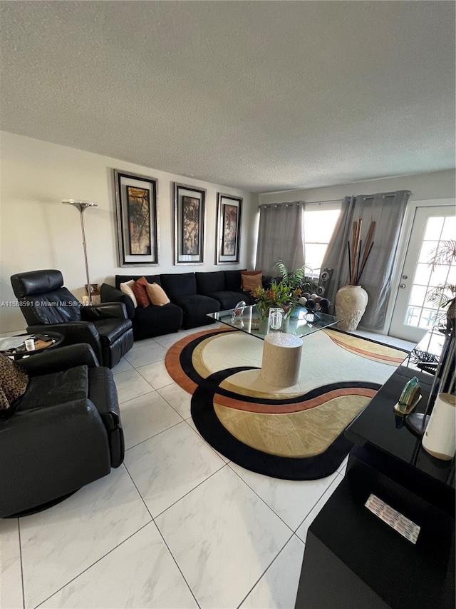 living room featuring tile patterned flooring and a textured ceiling