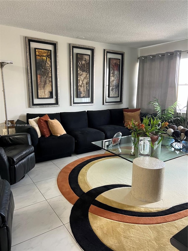 tiled living room featuring a textured ceiling